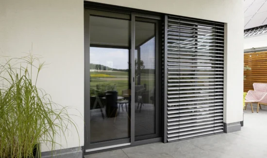 Moderne Terrassenverglasung mit Sonnenschutz und stilvoller Einrichtung